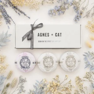 Presentset med tre rundade badbomber från Agnes + Cat med dofterna Provence, Seasalt & Moss och Windermere, omgiven av torkade blommor