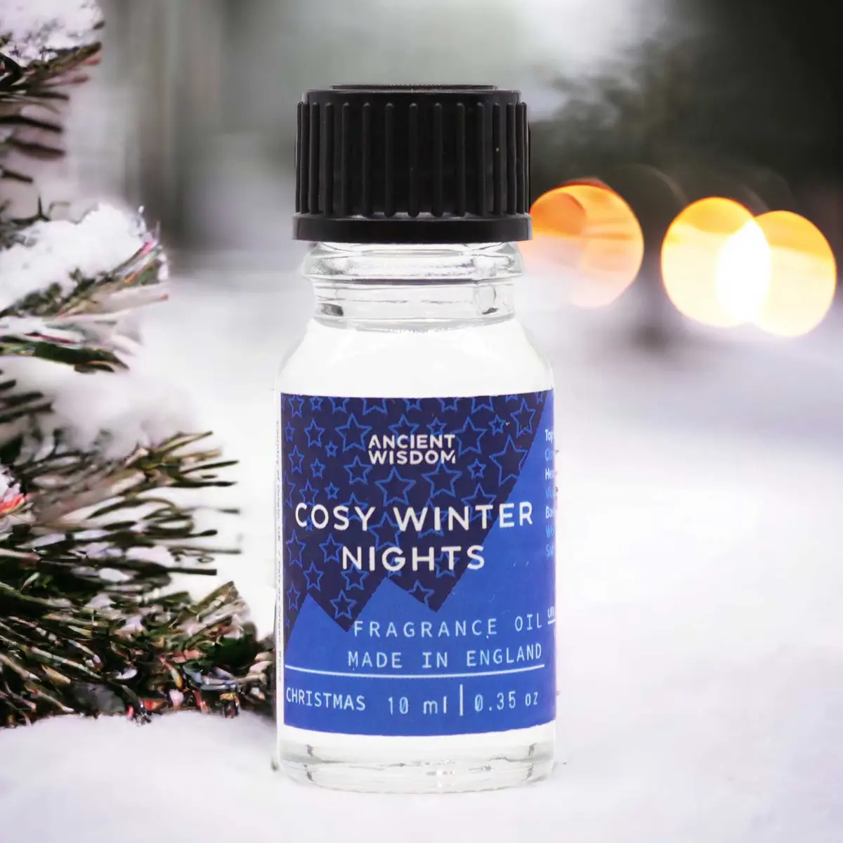 Flaska med Ancient Wisdom doftolja Cosy Winter Nights 10 ml med blå etikett och svart skruvkork