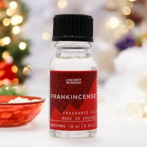 Flaska med Ancient Wisdom doftolja julrökelse 10 ml med röd etikett och svart lock