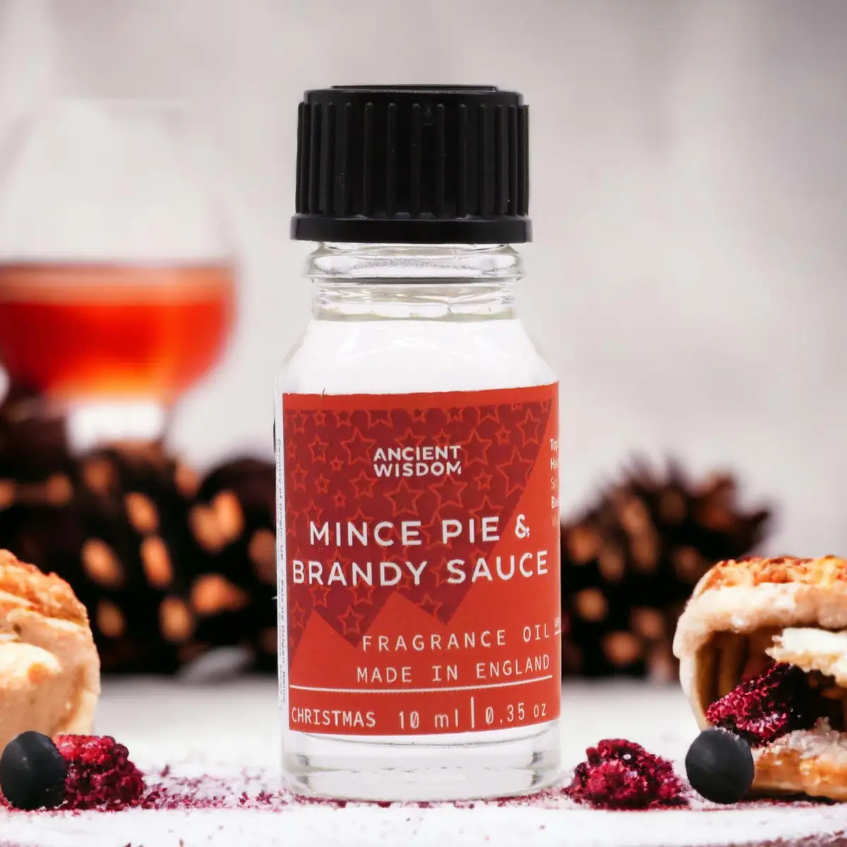 Flaska med Ancient Wisdom doftolja Mince Pie & Brandy Sauce 10 ml med juliga dekorationer
