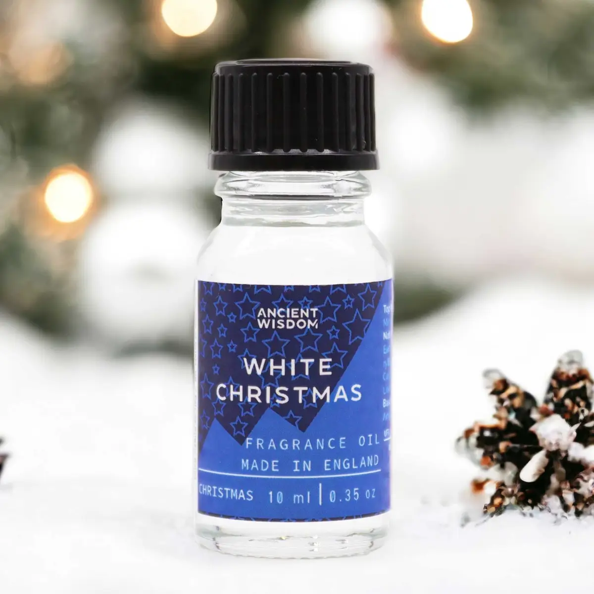 Flaska med Ancient Wisdom White Christmas doftolja 10 ml med blå etikett och svart lock