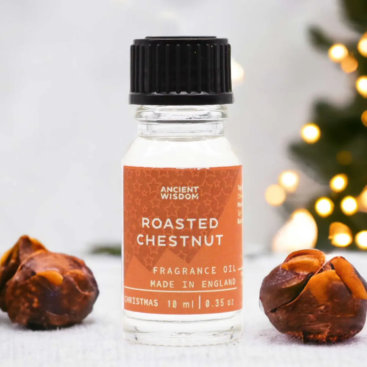 Flaska med Ancient Wisdom Rostad Kastanj doftolja 10 ml med rostade kastanjer runtom