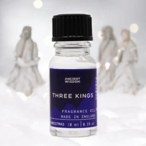 Flaska med Ancient Wisdom Three Kings doftolja 10 ml med suddig bakgrund av tre kungafigurer