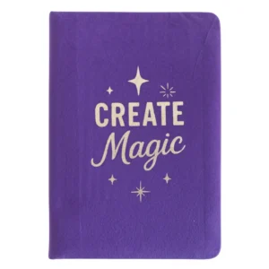 Lila anteckningsbok i sammet med texten Create Magic på omslaget