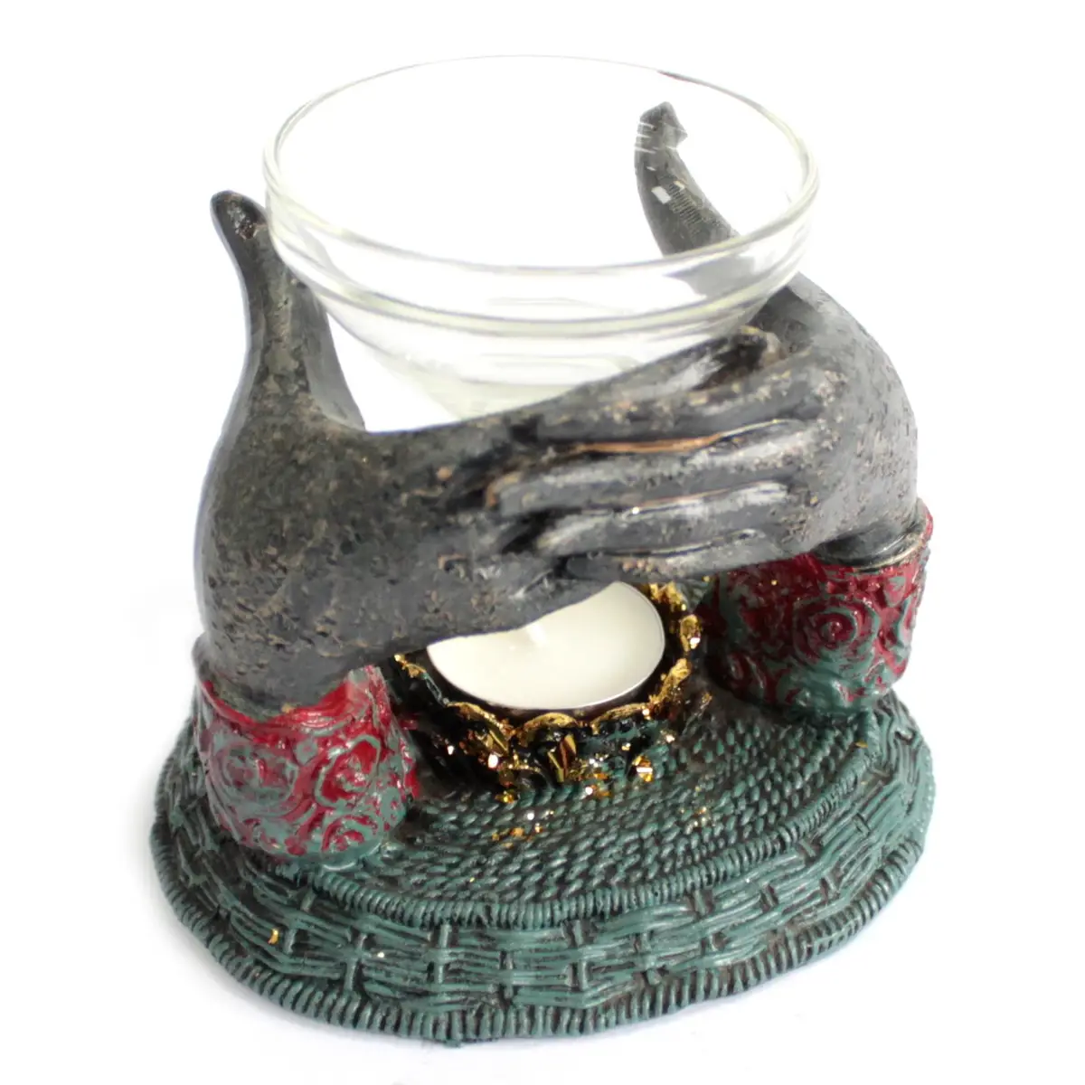 Oljebrännare med antik Buddha och händer som håller en glas-skål
