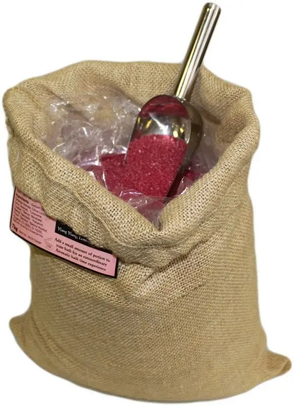 Jutesäck med rött aromaterapeutiskt badsalt och skopa