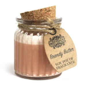 Doftljus i glasburk med korklock och etikett med texten Brandy Butter