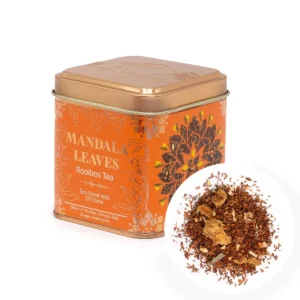 Ekologiskt rooibos-te i orange plåtburk med teblad och kryddor
