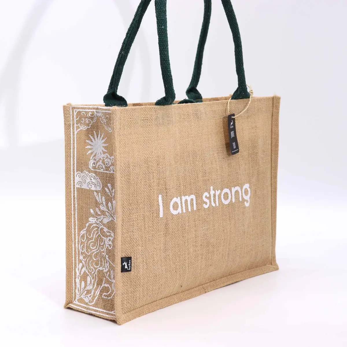 Hop Hare jutesäck i jute med texten I am Strong och gröna handtag