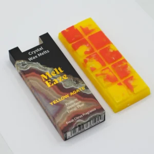 MeltEaze Golden Glow doftvax med gula och orange toner bredvid förpackning med gul agat-motiv