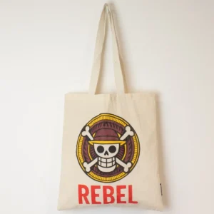 Naturfärgad bomullskasse med färgstarkt REBEL-tryck och långa handtag
