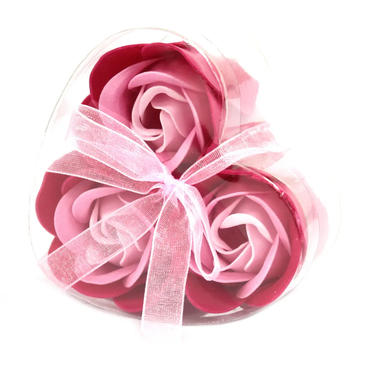 Tre rosa tvålblommor formade som rosor i hjärtformad genomskinlig ask med rosa band