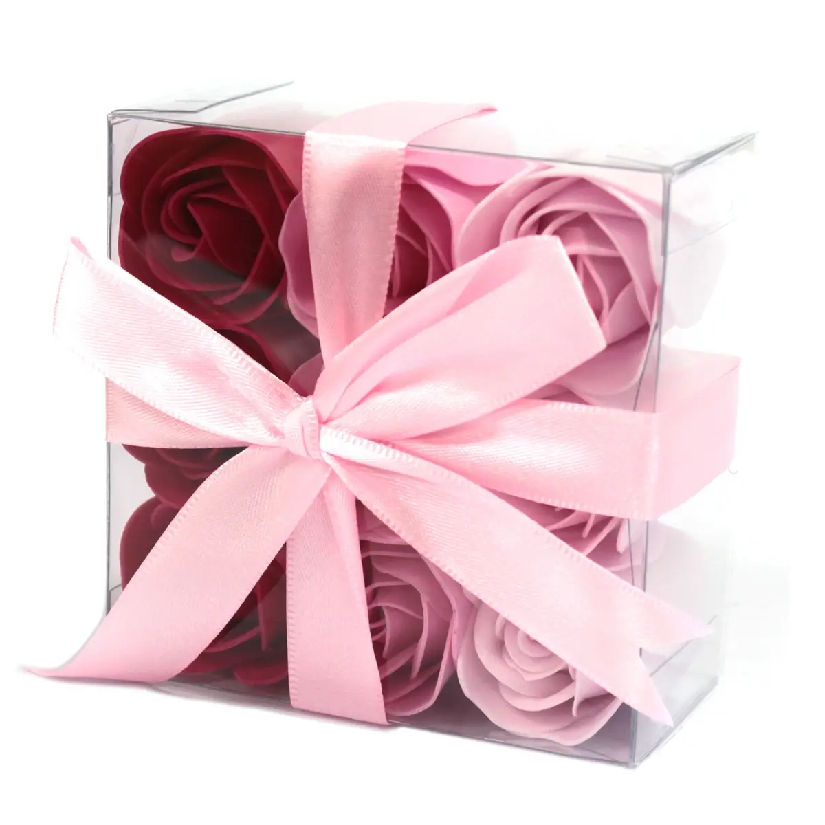 Set med nio tvålblommor i olika rosa nyanser förpackade i en genomskinlig ask med rosa sidenband