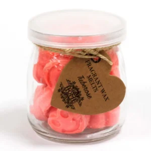Glasburk med rosa hjärtformade sojavaxsmältor och etikett med text Tuberos