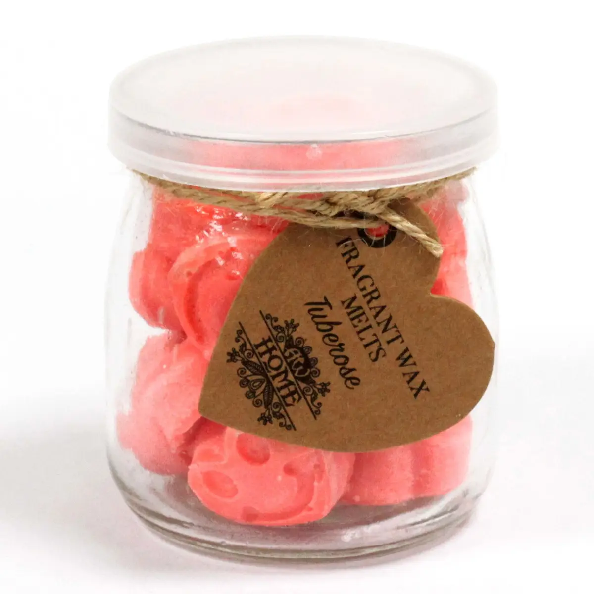 Glasburk med rosa hjärtformade sojavaxsmältor och etikett med text Tuberos