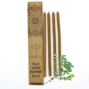 Fyra stora rökelsestickor av Palo Santo bredvid ett dekorativt kraftkuvert och en kvist eukalyptus
