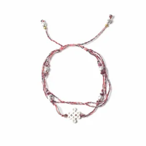 Temple-armband i röd, svart och vit tråd med dekorativa pärlor och symbol