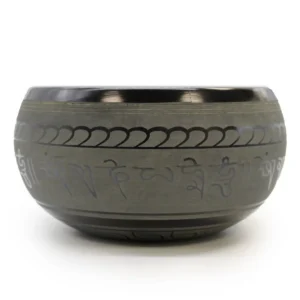 Tibetansk klangskål med dekorativa mönster och Buddha-motiv