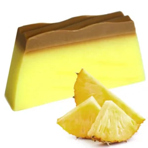 Tvålkaka med gul och brun färg bredvid skivor av färsk ananas