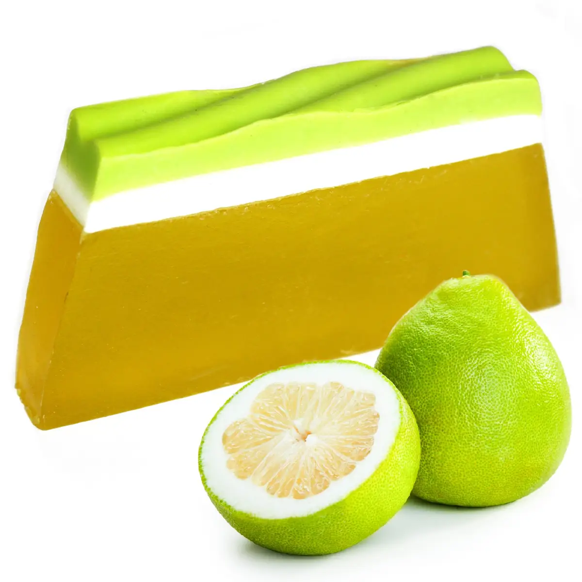 Tvålkaka med grön och vit topp och gul kropp bredvid hel och halverad pomelo
